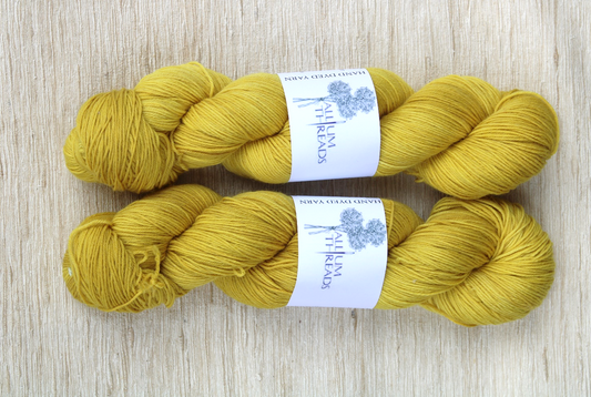 Yellow gold merino nylon four ply yarn