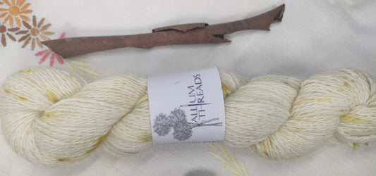 Bundle dyed speckled white double knit weight pure alpaca yarn