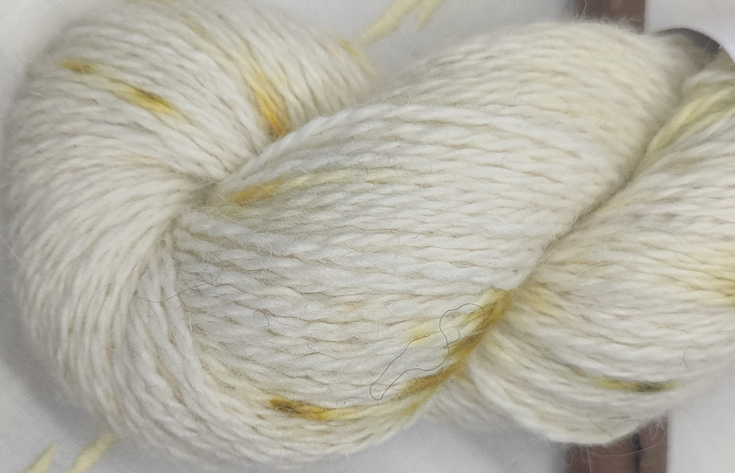 Bundle dyed speckled white double knit weight pure alpaca yarn